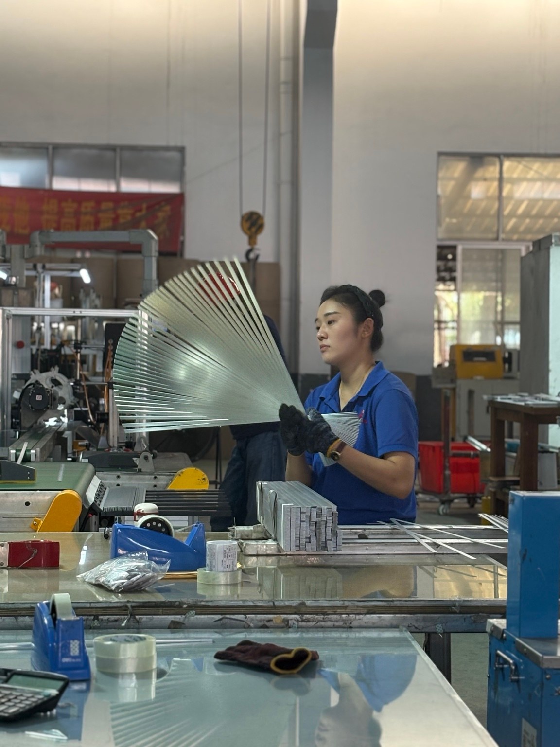 Operator working with aluminium components at production equipment